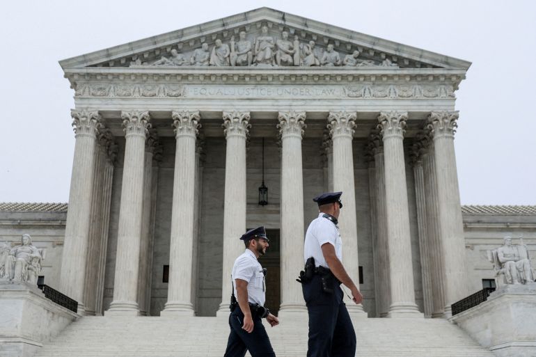 Police officers walk past the US Supreme Court in Washington, DC.