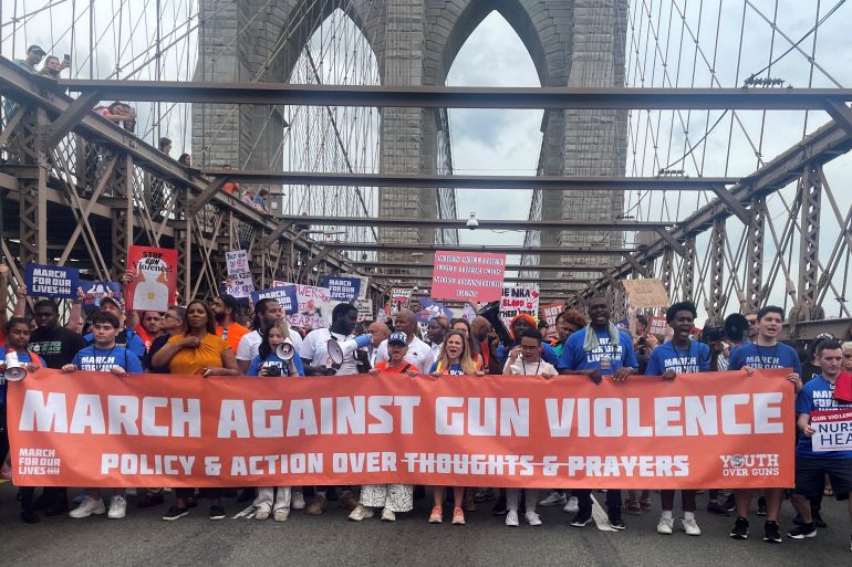 People cross the Brooklyn Bridge as they attend "March for Our Lives" rally, one of a series of nationwide protests against gun violence, New York City