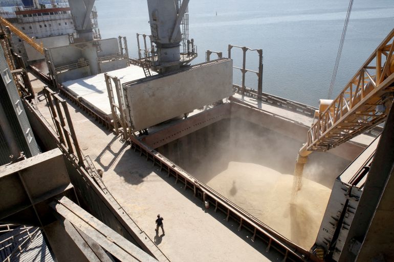 A dockyard worker watches as barley grain is mechanically poured into a 40,000 ton ship at a Ukrainian agricultural exporter's ship in Nikolaev, Ukraine.