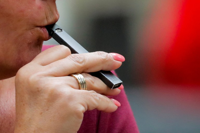 A woman smokes a Juul e-cigarette in New York, U.S