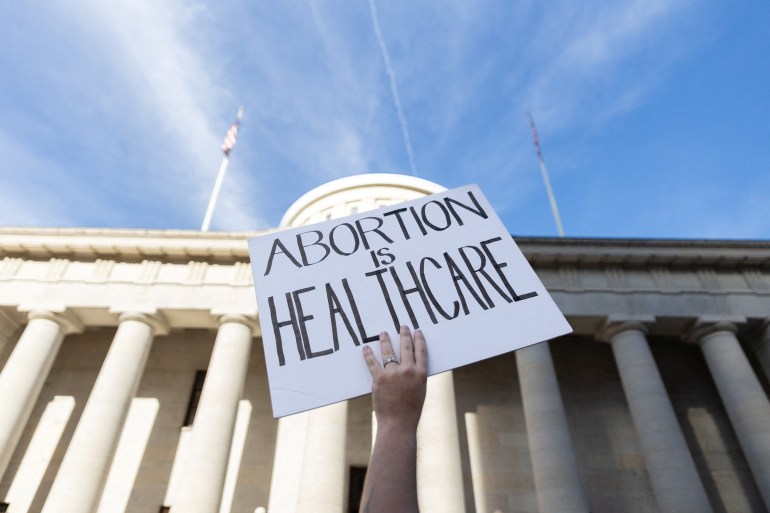 A protester holds a sign reading 'abortion is healthcare' in Columbus, Ohio