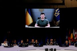 Ukraine's President Volodymyr Zelenskyy appears on the screen during a NATO summit