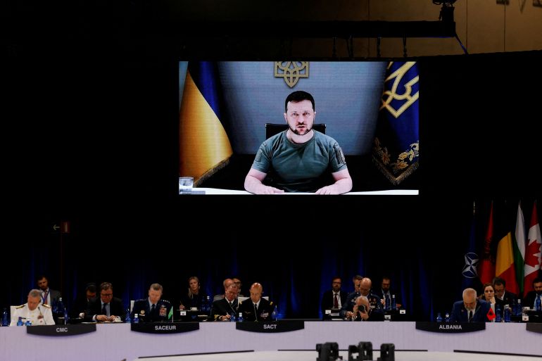 Ukraine's President Volodymyr Zelenskyy appears on the screen during a NATO summit