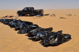 Recovered bodies of migrants lie in bags in the area between Kufra city and Chadian border with Libya [Reuters]