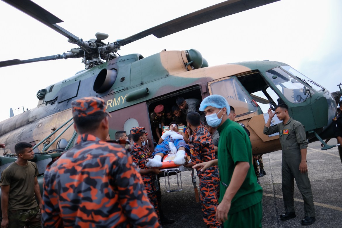 A man injured in a massive fire that broke out around midnight Saturday at the BM Inland Container Depot, at Chittagong in south-eastern Bangladesh is taken for treatment after being airlifted by the army in Dhaka.