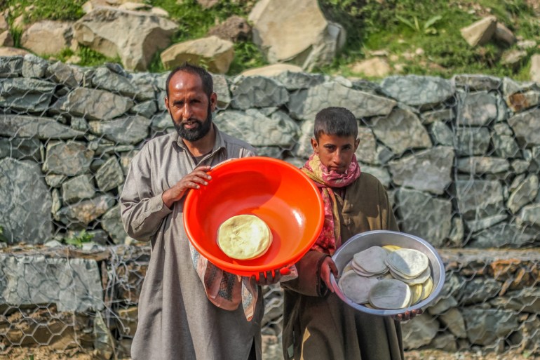 Farooq and Faizan pose for the camera, each holding a bowl of kaladis