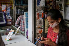 A medical store advertises the use of the Google Pay and Amazon Pay digital payment systems in Mumbai, India