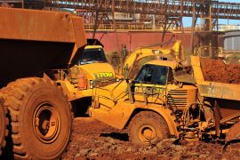 Excavators and trucks load and move nickel ore in Townsville, Queensland, Australia