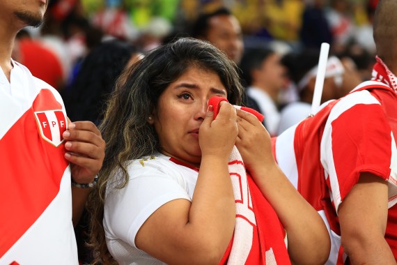 A Peruvian fan cries after her sides loss to Australia