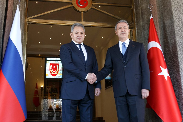 Turkish Defence Minister Hulusi Akar, right, and Russia's Defense Minister Sergei Shoigu pose for a photo during their meeting in Ankara, Turkey, Monday, Feb. 11, 2019.