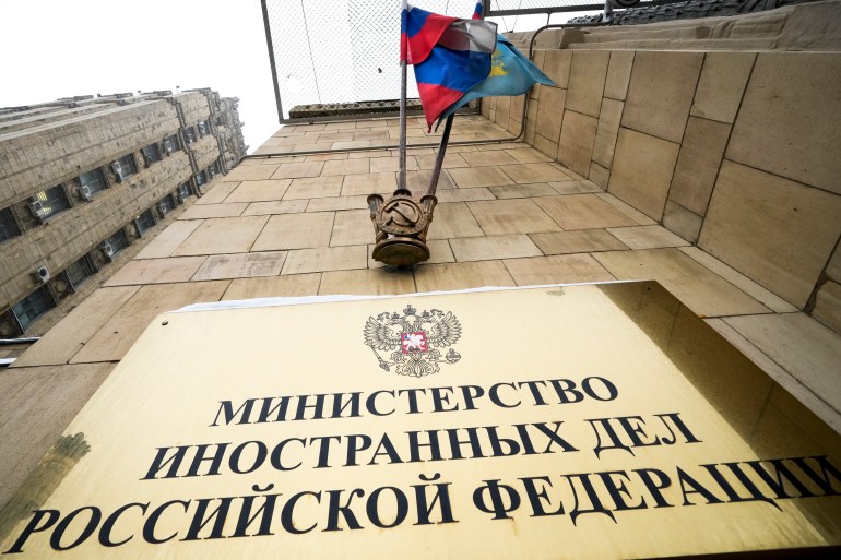 A Russian national flag hangs above the sign of the Russian Foreign Ministry building in Moscow [File photo: Alexander Zemlianichenko/AP]