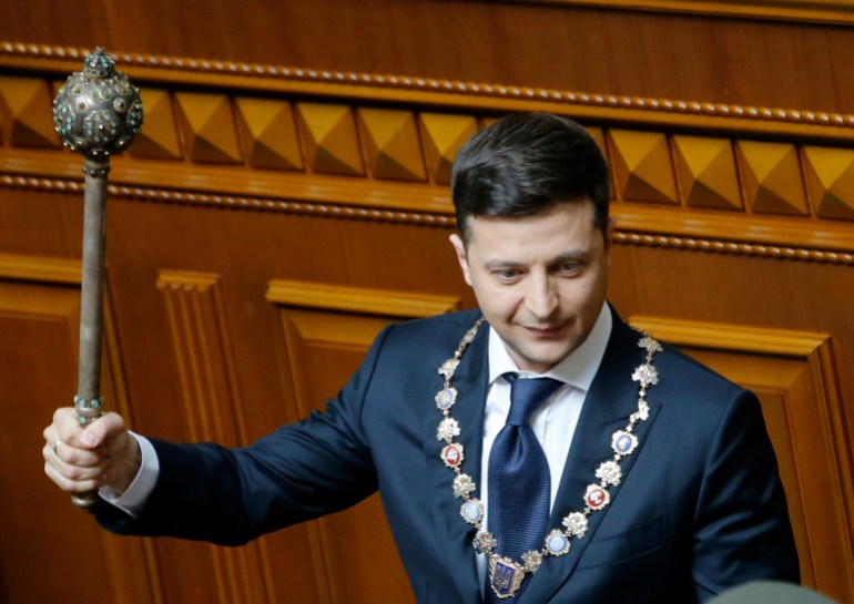 Volodymyr Zelenskyy holds aloft the mace at his inuauguration in 2019