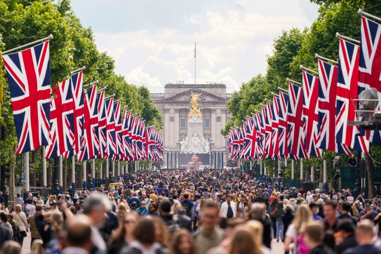 People are seen walking along The Mall in London as the Queen's Platinum Jubilee celebrations begin