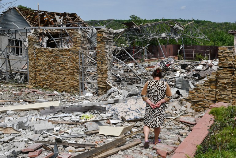 An elderly woman walks next to a building damaged by an overnight missile strike in Sloviansk, Ukraine, 