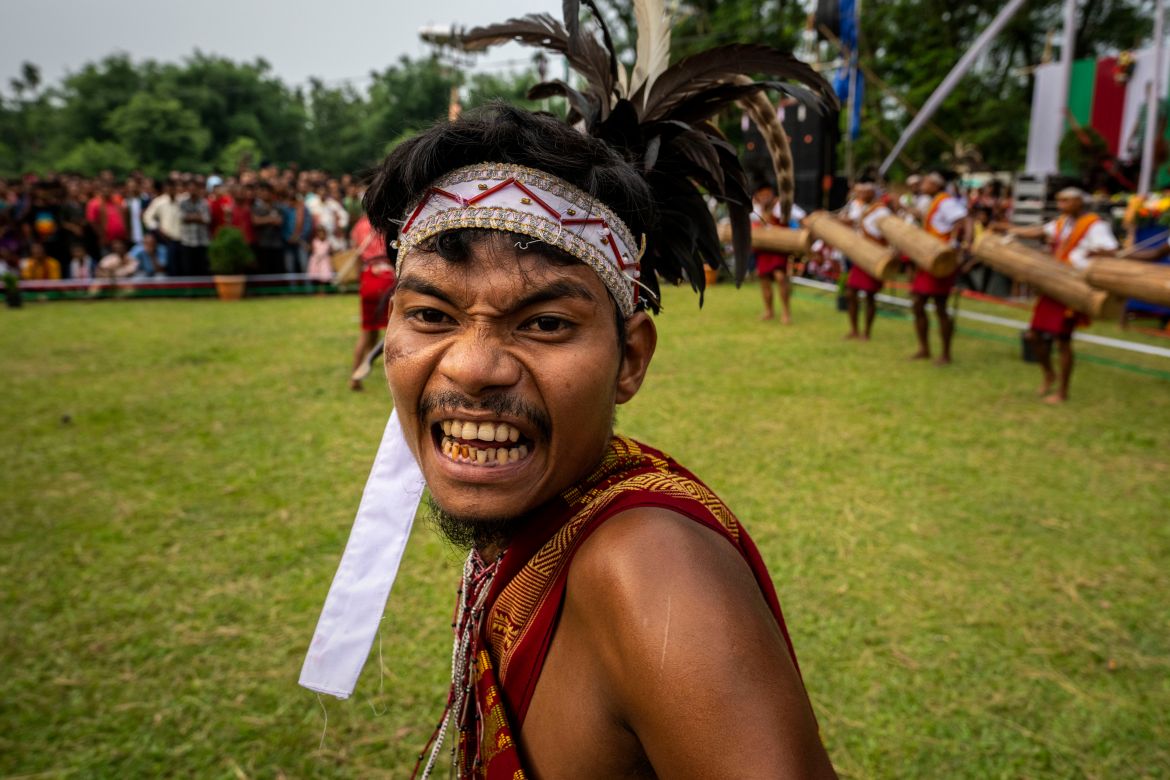 An Indian Garo tribal in traditional attire performs a traditional dance during Baikho festival