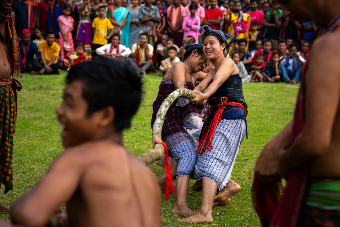 Indian Rabha tribal women in traditional attire take part in a tug of war competition with men during Baikho festival