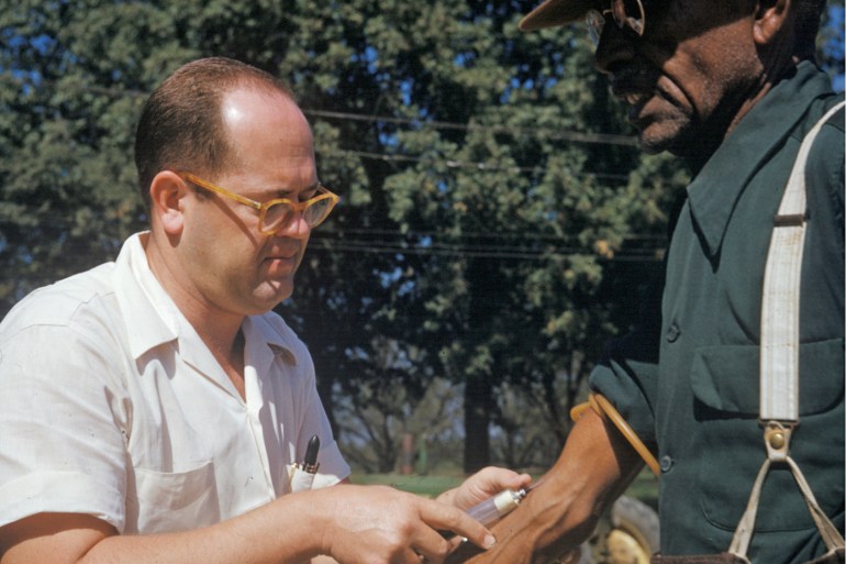 In this 1950's photo released by the National Archives, a Black man included in a syphilis study has blood drawn by a doctor in Tuskegee, Alabama. Fifty years after the infamous Tuskegee syphilis study was revealed to the public in 1972 and halted, Manhattan-based philanthropy organisation Milbank Memorial Fund is publicly apologising for its role in the infamous study [File photo: National Archives/AP]