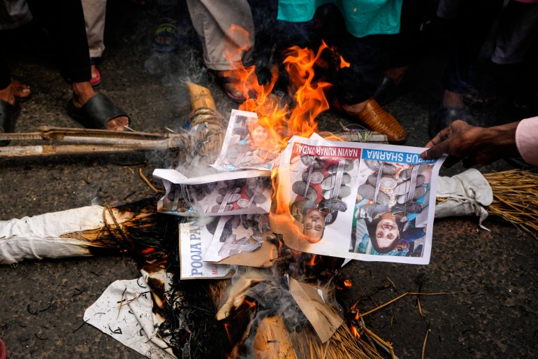 Indian Muslims burn an effigy with a portrait of BJP leader Nupur Sharma.
