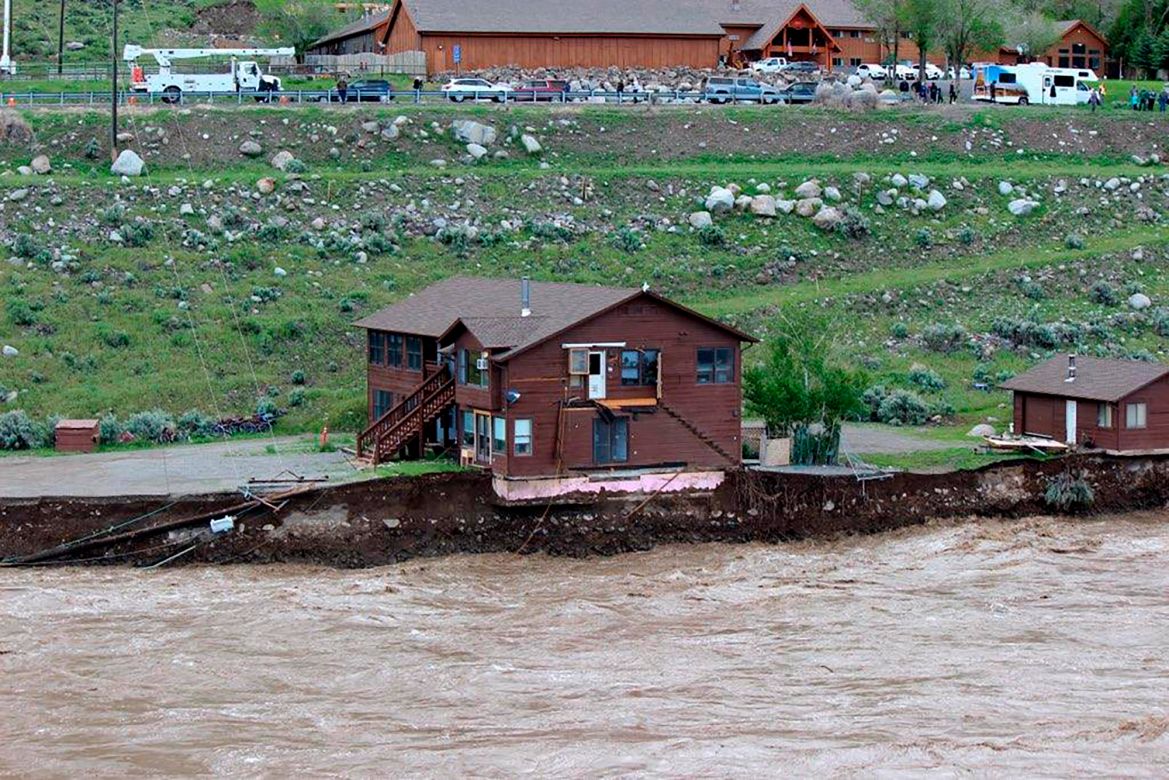 In this image provided by Sam Glotzbach, the flooding Yellowstone River undercuts the river bank