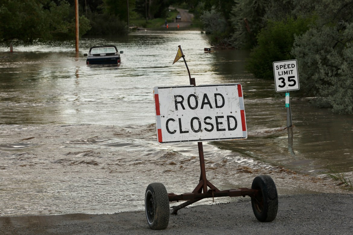 A road is closed from floodwaters along the Clarks Fork Yellowstone River near Bridger