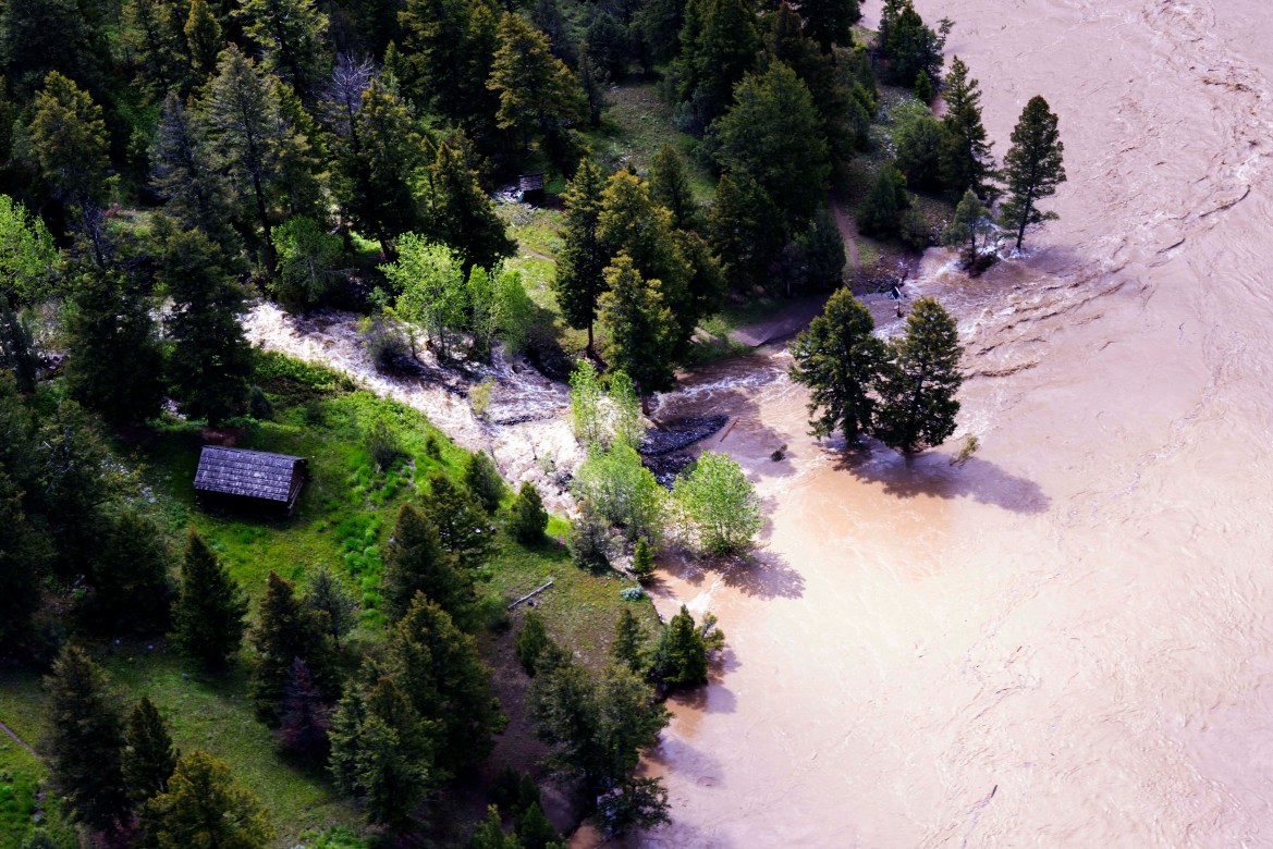 This aerial photo provided by the National Park Service shows the Lower Blacktail Patrol Cabin washed away in Yellowstone National Park