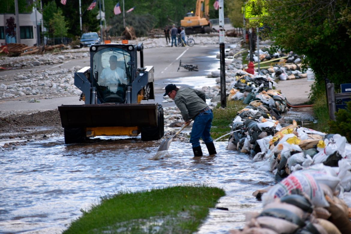 Residents of Red Lodge, Montana, are seen clearing mud, water and debris from the small city's main street