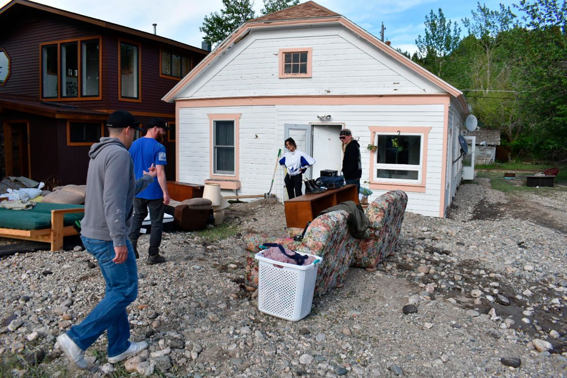 Residents of Red Lodge, Mont., inspect damage to a house that was flooded after torrential rains fell across the Yellowstone region