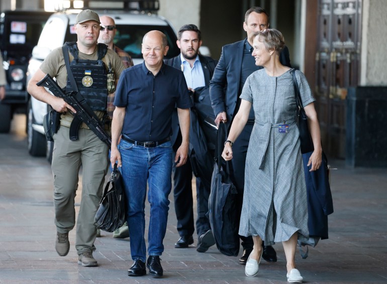 German Chancellor Olaf Scholz is escorted as he arrives at the Kyiv train station, Thursday, June 16, 2022. French President Emmanuel Macron Prime Minister Mario Draghi and German Chancellor Olaf Scholz are expected to meet with Ukraine's President Volodymyr Zelenskyy as they prepare for a key European Union leaders' summit in Brussels next week and a June 29-30 NATO summit in Madrid.