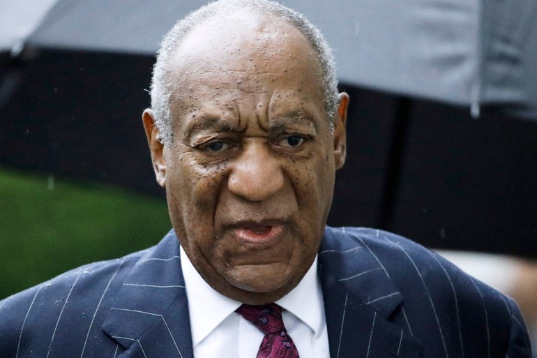 Bill Cosby wearing a white shirt, tie and suit during an earlier sexual assault case against him