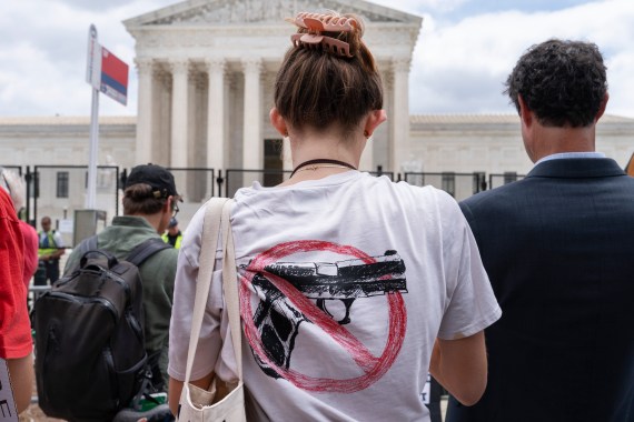 A woman wears an anti-gun T-shirt outside of the Supreme Court, following the Supreme Court's decision to overturn Roe v. Wade in Washington, Friday, June 24, 2022. The Supreme Court on Thursday struck down a New York state law that had restricted who could obtain a permit to carry a gun in public [Jacquelyn Martin/AP]