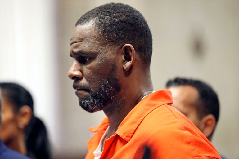 US singer R Kelly appears at a court hearing in an orange prison jumpsuit