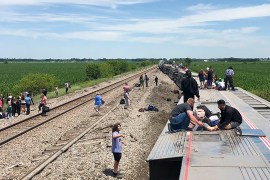 Amtrak says the train derailed after hitting a dump truck obstructing a public crossing in a remote area in the US state of Missouri on Monday [Dax McDonald via AP Photo]