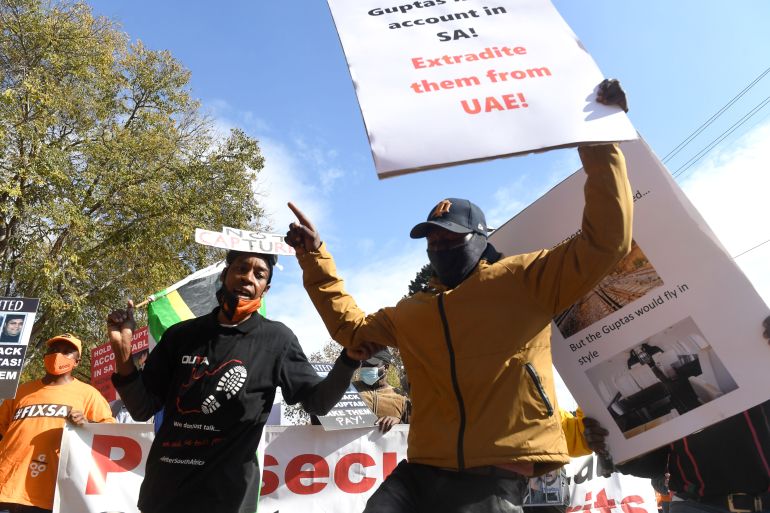 A group of people protest outside the United Arab Emirates' (UAE) embassy calling for the speedy extradition of the Guptas