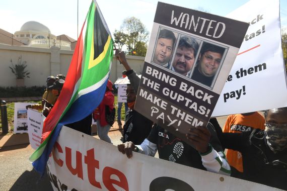 A group of people protest outside the United Arab Emirates' (UAE) embassy calling for the speedy extradition of the Guptas on June 10, 2021 in Pretoria, South Africa. It is reported that Gupta brothers Atul and Rajesh, and their wives Chetali and Arti and 17 others were accused on a charge of money laundering of R24.9 million.