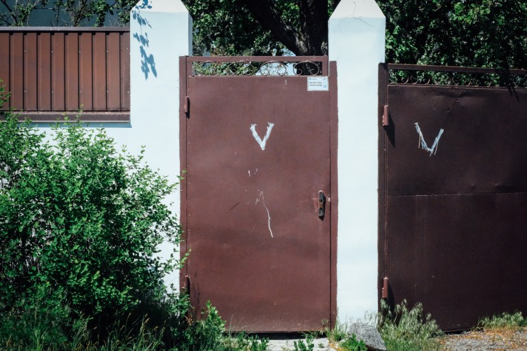 A view of a door with a painting V on the upper half of the door.