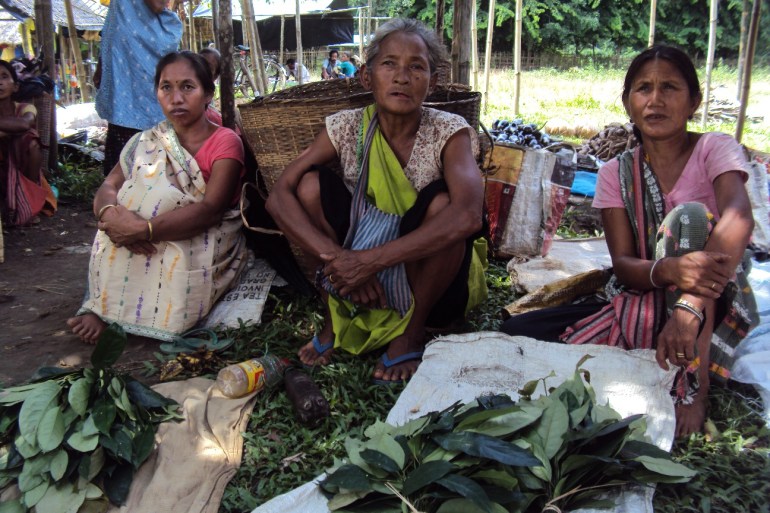 Female farmers selling their foraged herbs in the market