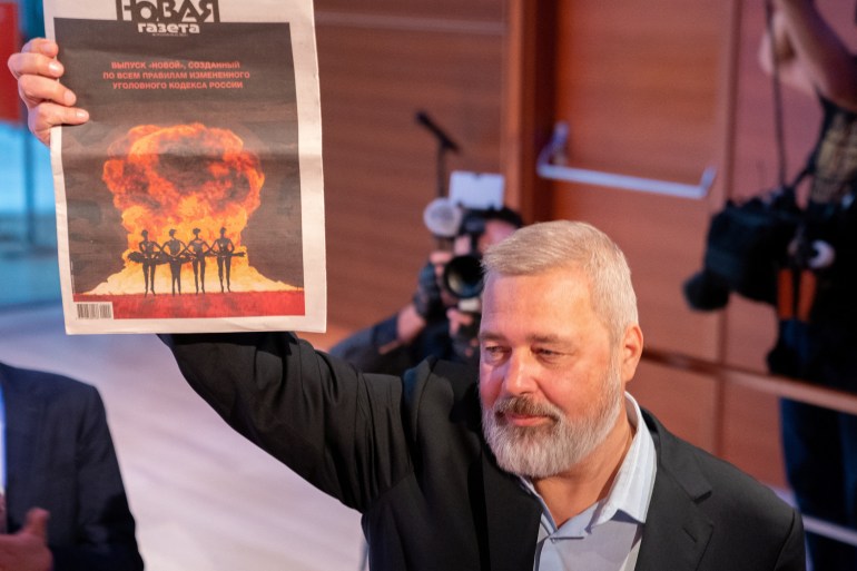 Dmitry Muratov holds a copy of his newspaper the Novaya Gazeta after his 2021 Nobel Peace Prize medal sold for 103.5 Million by Heritage Auctions in New York City, New York, U.S., June 20, 2022