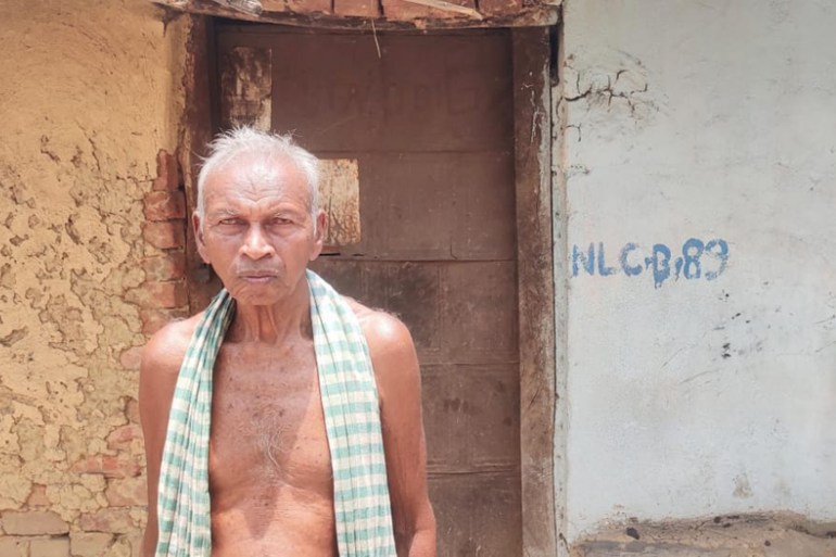 Nityananda Deep stands outside her house, which has been marked for demolition