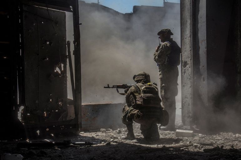 Ukrainian service members watch while a tank (not pictured) fires toward Russian troops in the industrial area of the city of Severodonetsk, Ukraine June 20, 2022