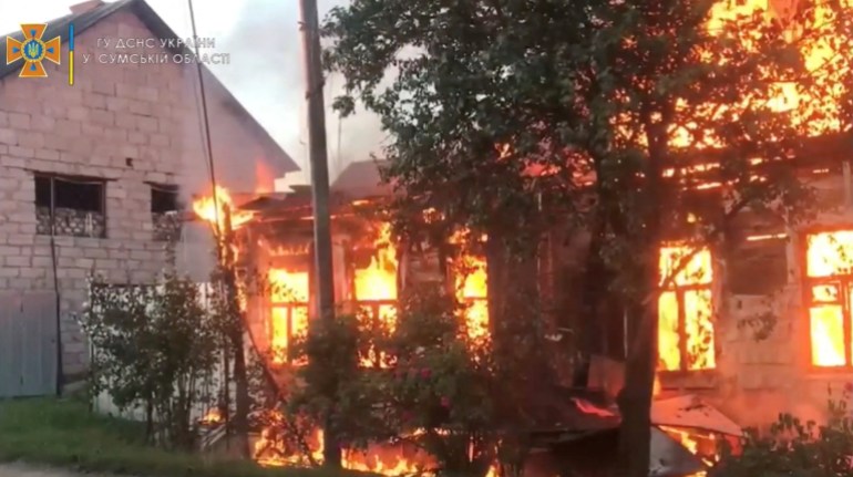 A fire is burning in a building after the shelling of a place called Sredina-Buda, Sumy region