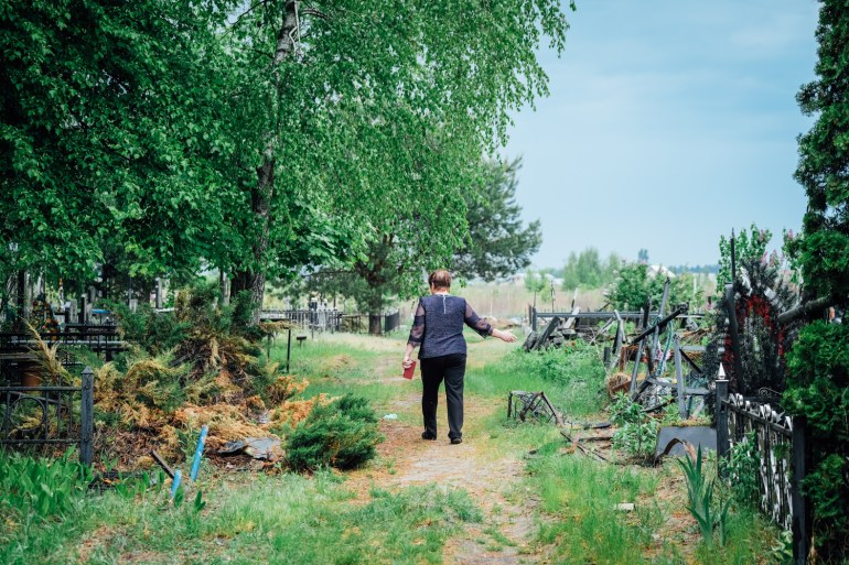 Una foto de Ludmila Zakabluk caminando por un cementerio.