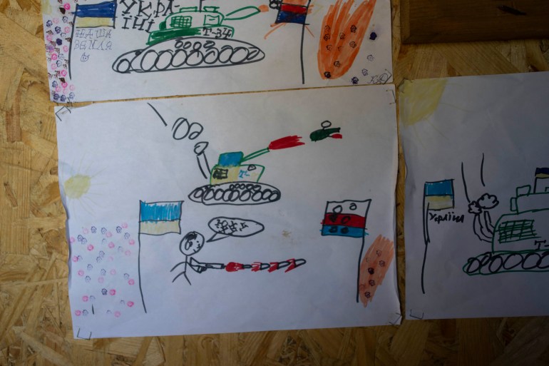 Drawings by Ukrainian children decorate a sleeping area in a trench near the front lines in the Donetsk region, eastern Ukraine, Wednesday, June 8, 2022
