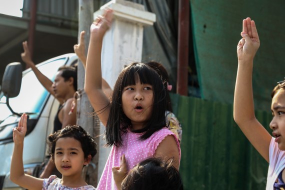 Children show the three fingered salute in opposition to the Myanmar coup