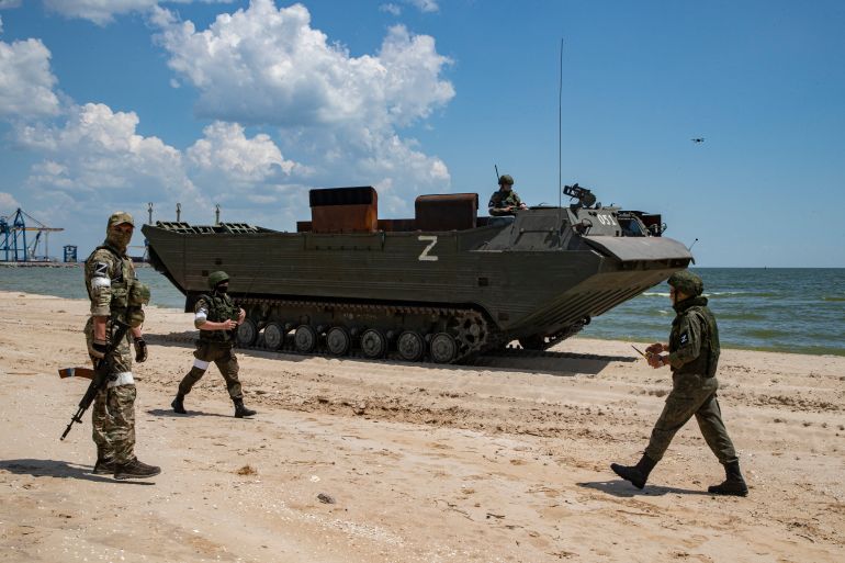 Russian servicemen prepare to demine Peschnaya beach near the cargo sea port of Mariupol, Ukraine