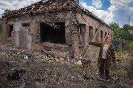 Tetyana points at her house heavily damaged by Russian shelling in Bakhmut, Donetsk region, Ukraine, Friday, June 24, 2022 [Efrem Lukatsky/AP]