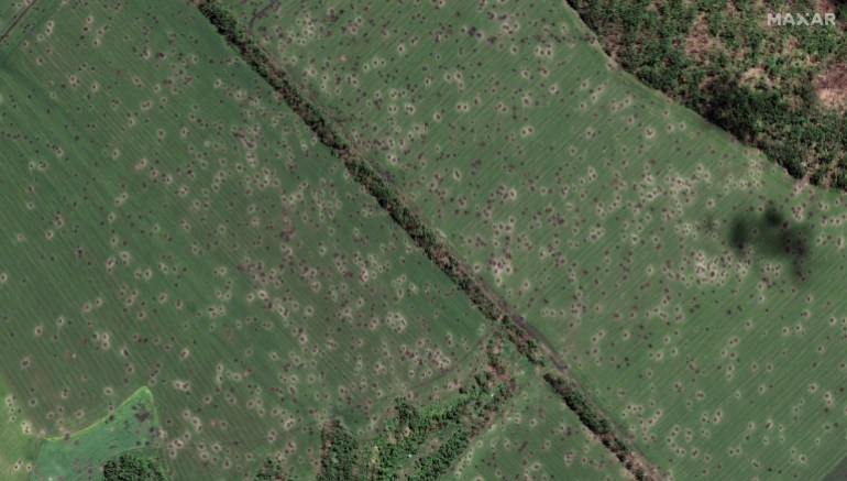 A satellite image shows fields peppered with artillery craters, north west of Slovyansk