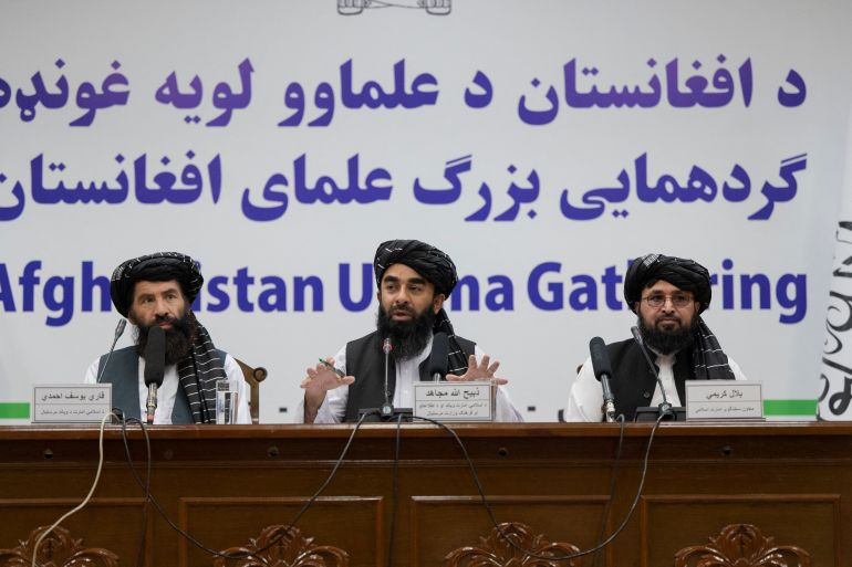 Taliban spokesman Zabihullah Mujahid (C) speaks during a press conference in Kabul.