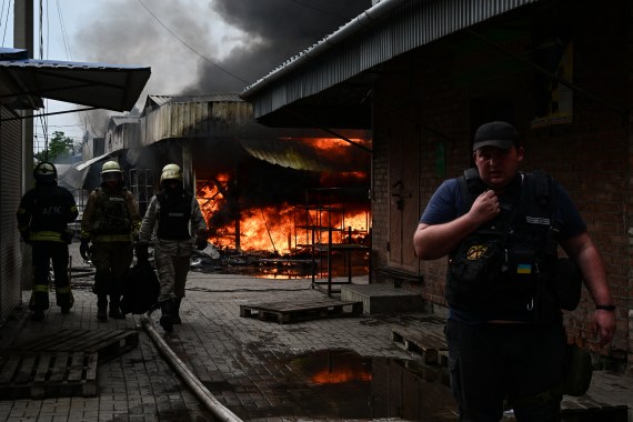 Firefighters work to control flames at the central market of Sloviansk