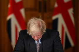 Johnson looks down at the podium as he attends a press conference [File: Justin Tallis/Pool/AFP]