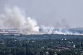 Smoke billows during an artillery exchange between Ukrainian army and Rusian army on the outskirts of the city of Sloviansk.
